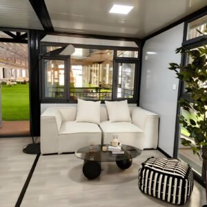 Prefabia luxury modular home living room with sofa and floor-to-ceiling glazing – MOB TIMBERCREST
