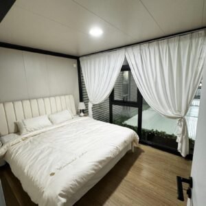 MOB TIMBERCREST modular home bedroom with king bed and glazed wall to terrace